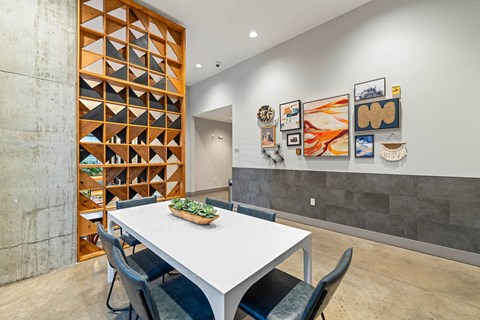 a dining room with a white table and chairs